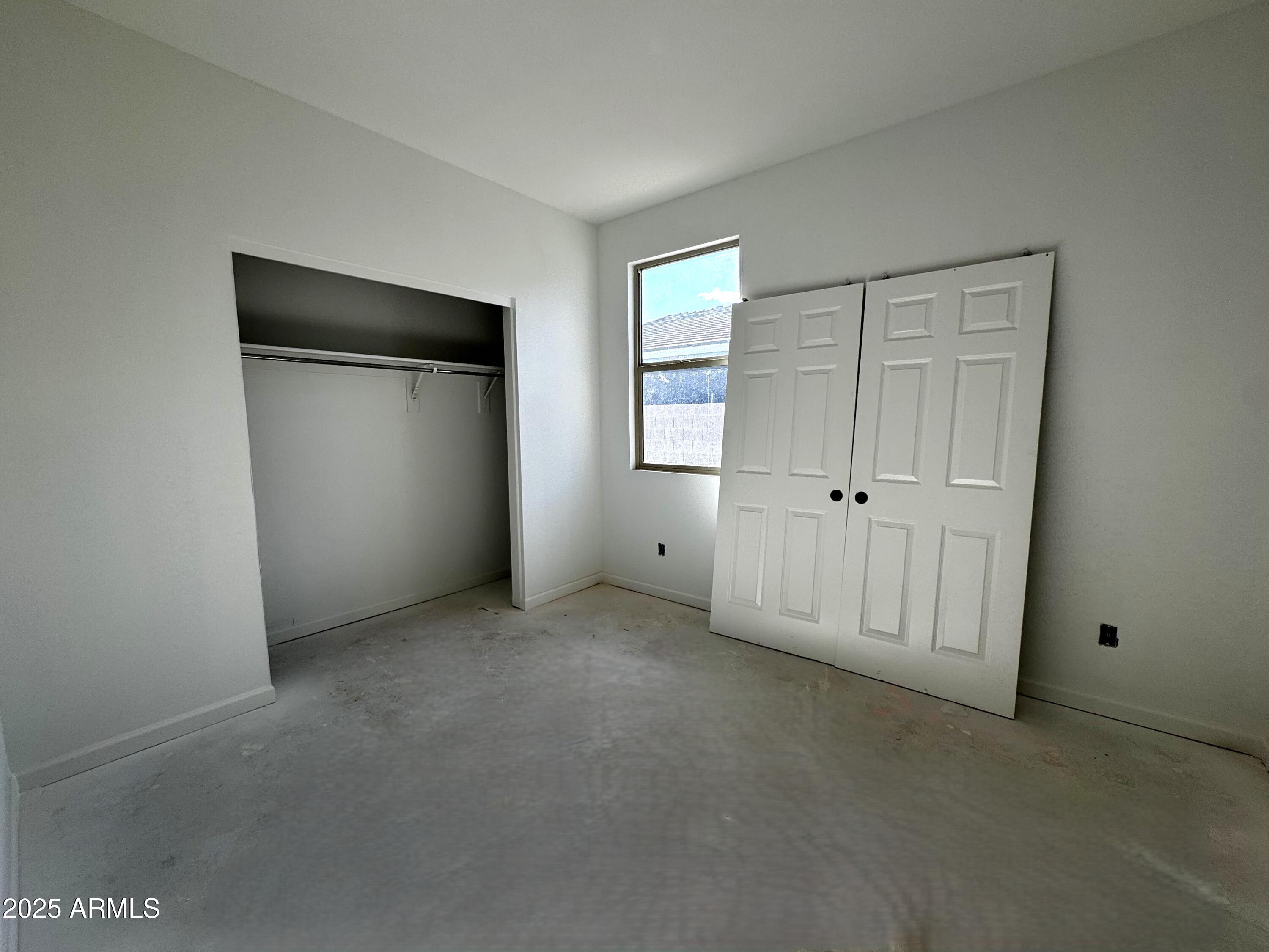 46835 West Old Timer Road Maricopa, AZ 85139 - Photo 13 of 25 a view of an empty room with a window