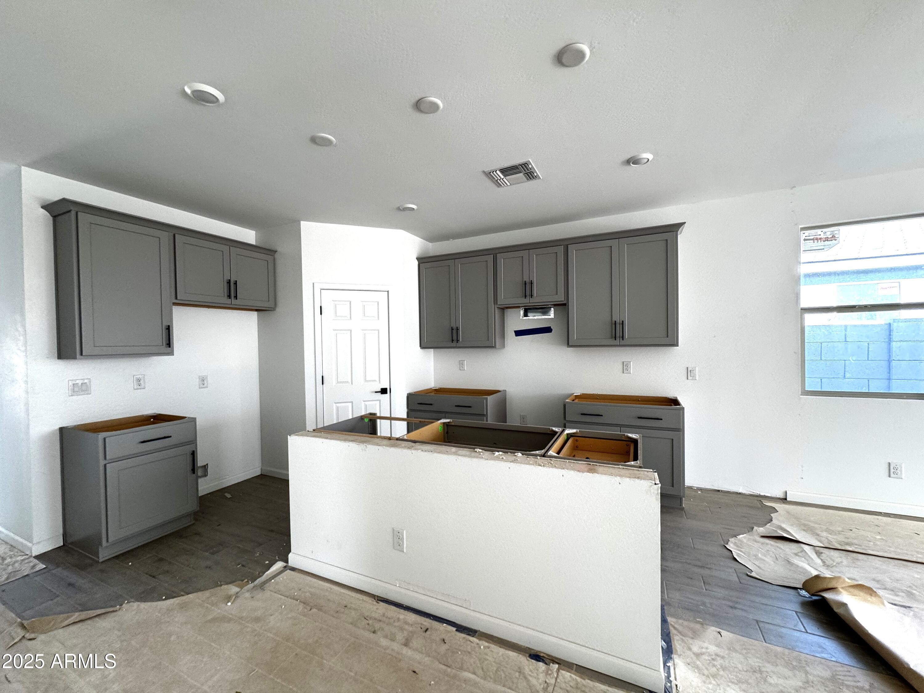 46835 West Old Timer Road Maricopa, AZ 85139 - Photo 7 of 25 a kitchen with stainless steel appliances a stove a sink and a refrigerator