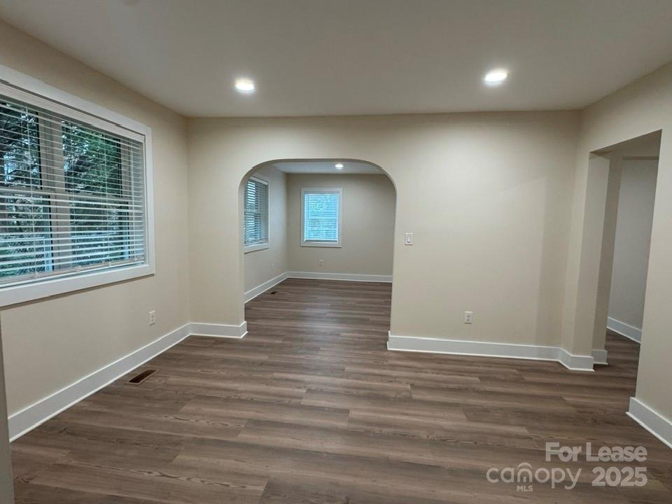 19612 Oak Street, Unit 9 Cornelius, NC 28031 - Photo 8 of 17 an empty room with wooden floor and windows