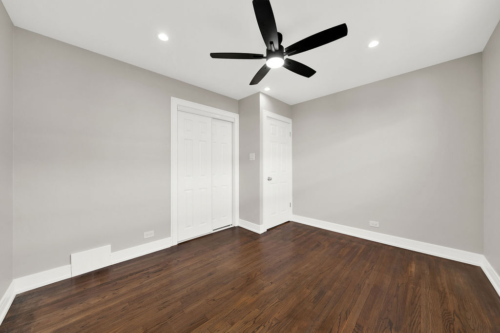 7725 South Albany Avenue Chicago, IL 60652 - Photo 15 of 25 an empty room with wooden floor ceiling fan and window