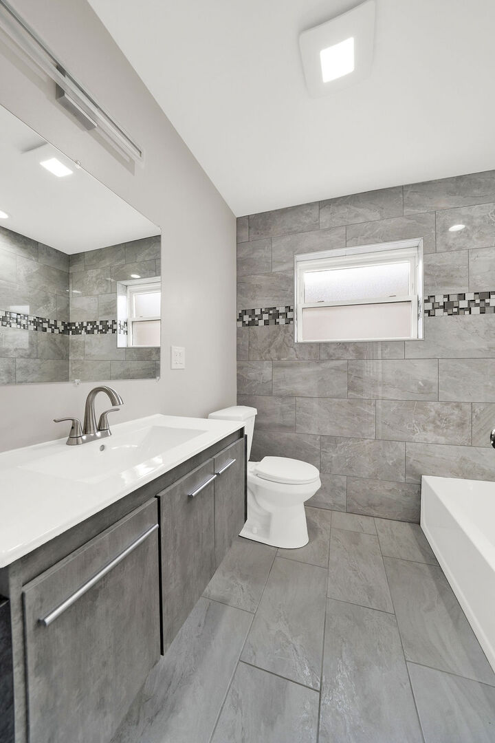 7725 South Albany Avenue Chicago, IL 60652 - Photo 19 of 25 a bathroom with a sink a toilet and mirror