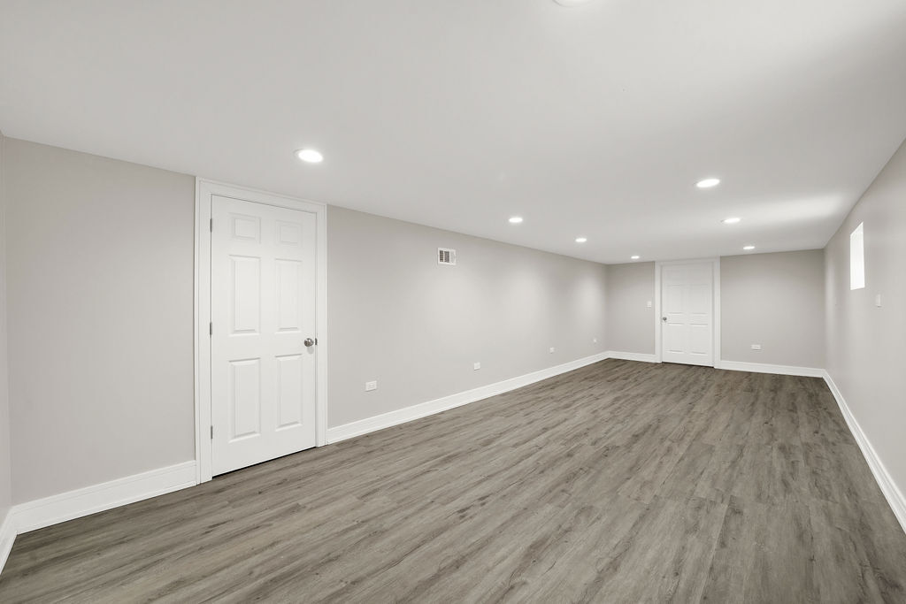 7725 South Albany Avenue Chicago, IL 60652 - Photo 21 of 25 a view of an empty room with wooden floor