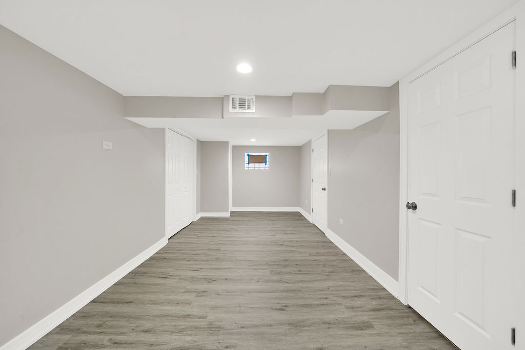 7725 South Albany Avenue Chicago, IL 60652 - Photo 24 of 25 a view of an empty room with wooden floor