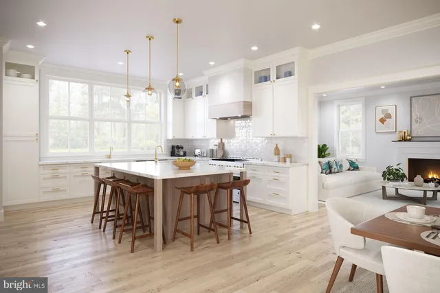a kitchen with kitchen island a dining table chairs and wooden floor