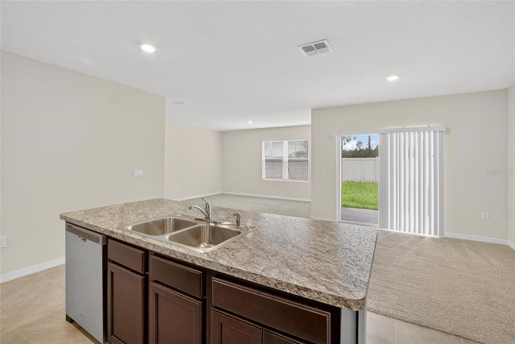 820 Sun Burst Road Winter Haven, FL 33880 - Photo 18 of 29 a kitchen with a sink and cabinets