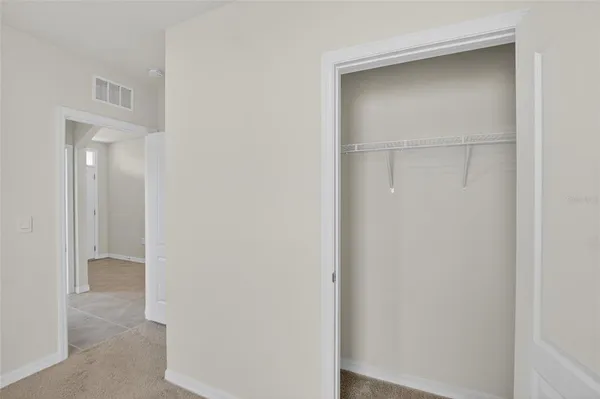 a view of an empty room and a window