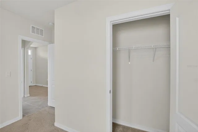 a view of an empty room and a window