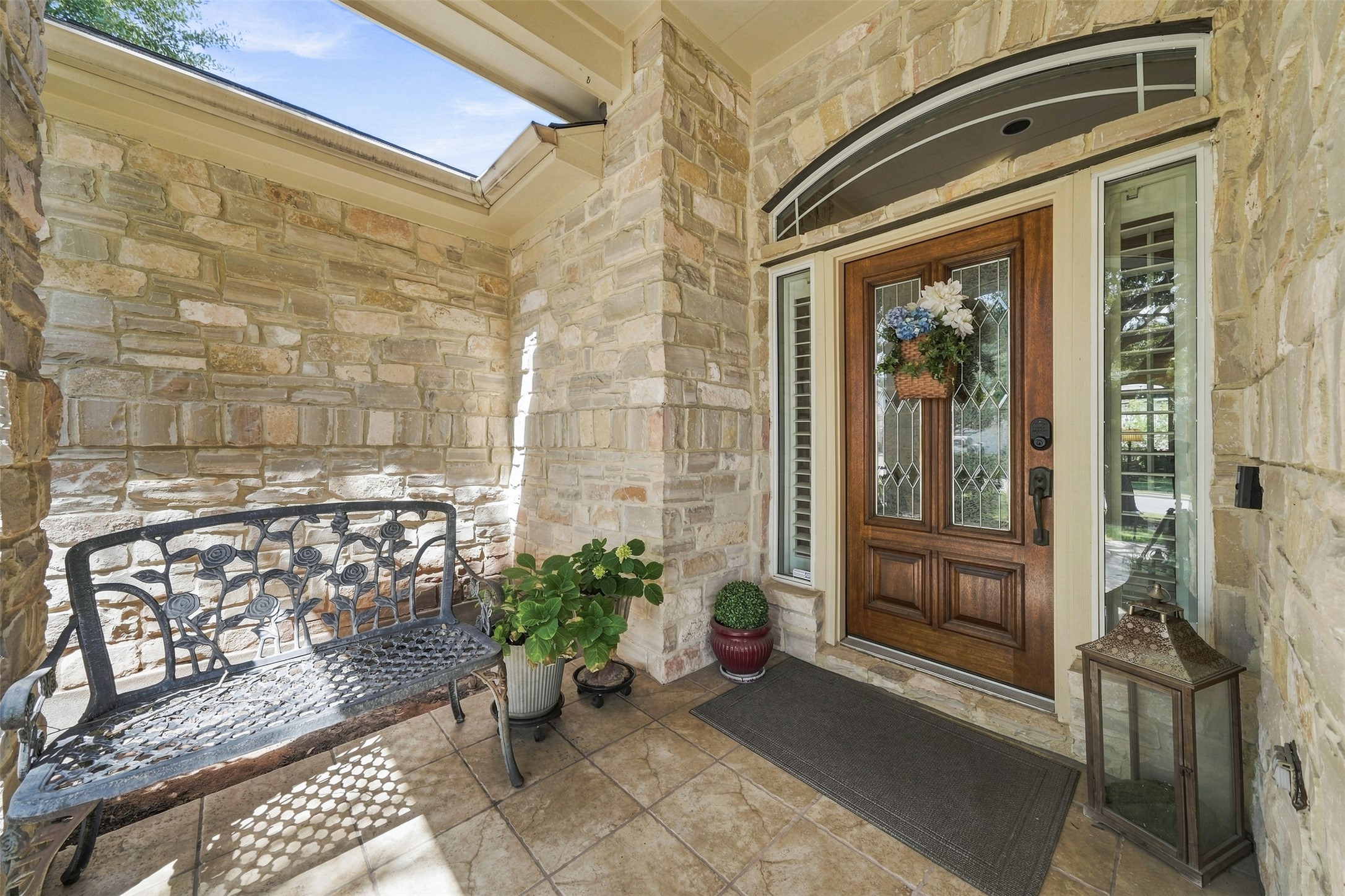 402 Ridgetop Bend Cedar Park, TX 78613 - Photo 4 of 40 An inviting stone entryway features a rich wood front door under a skylight.