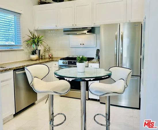 a view of kitchen and dining area with furniture