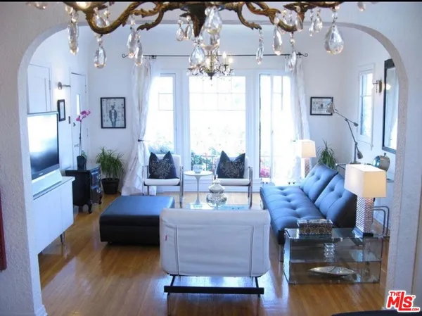 a living room with furniture and a chandelier