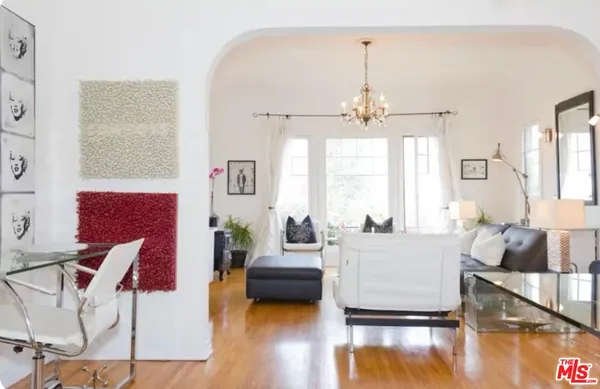 a living room with furniture and a wooden floor