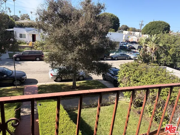 a view of a balcony with two chairs and a table