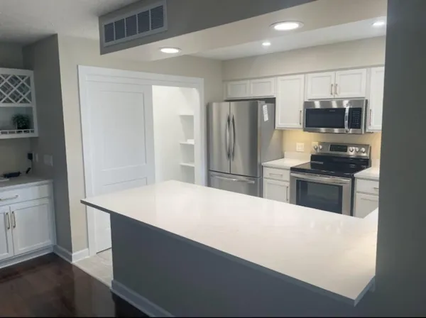 a bedroom with a bed and a mirror