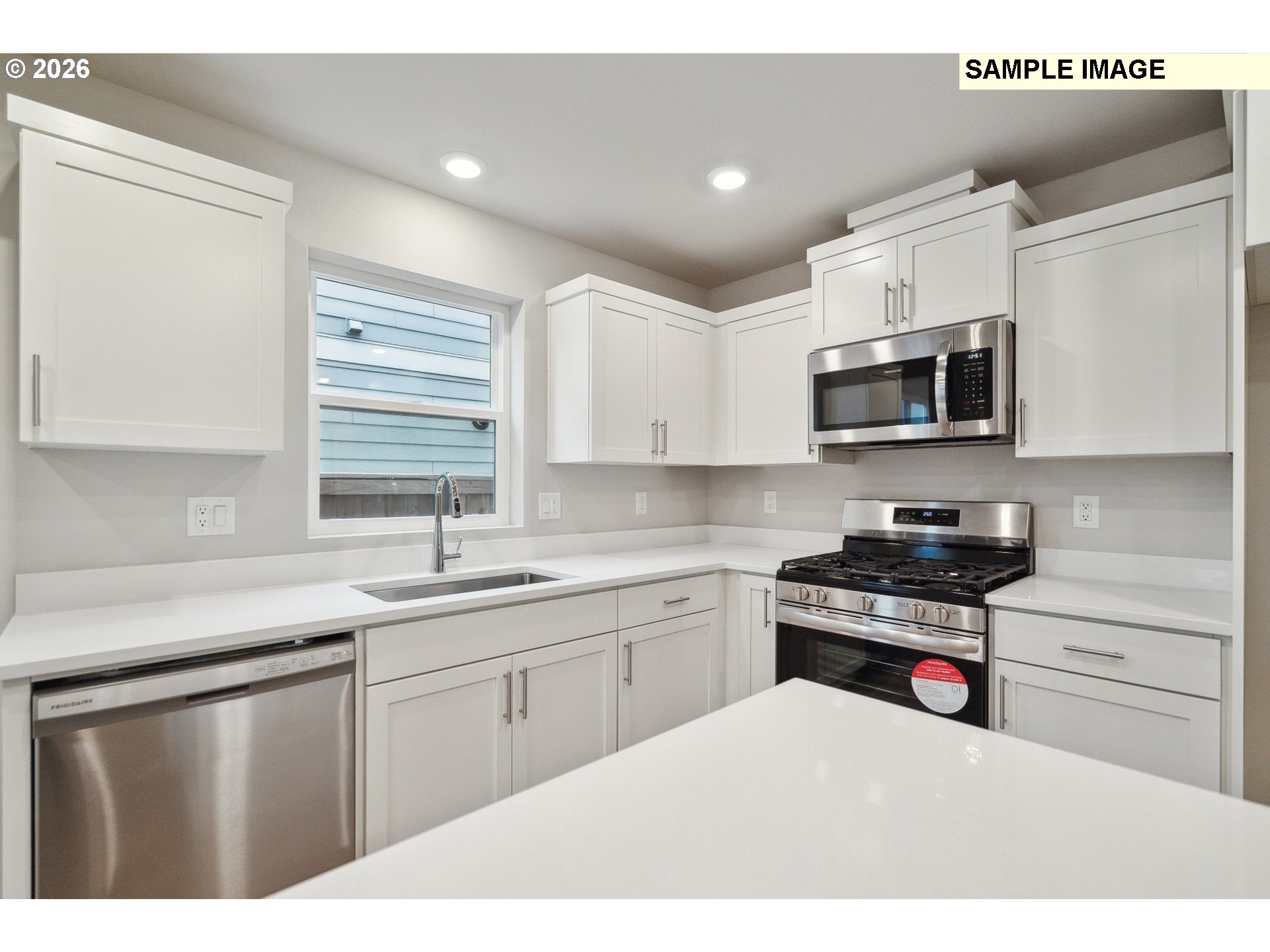 740 Merriott Lane Woodburn, OR 97071 - Photo 4 of 17 a kitchen with stainless steel appliances a sink dishwasher stove refrigerator and microwave