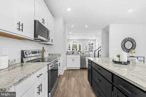 a kitchen with stainless steel appliances granite countertop a sink and stove top oven