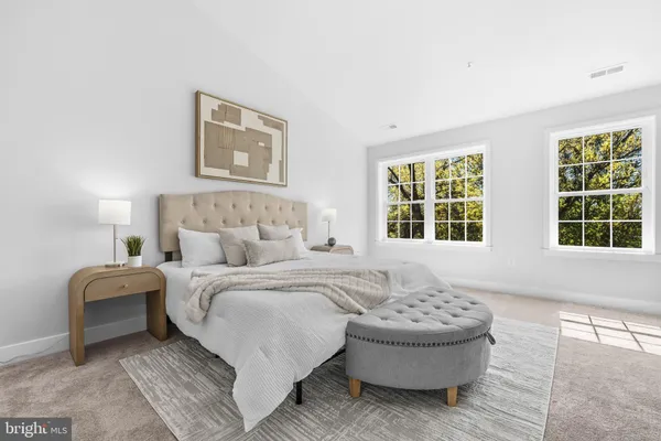 a bedroom with a large bed and a large window