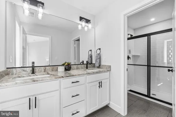 a bathroom with a granite countertop sink mirror and double