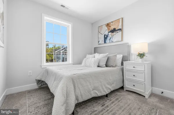 a bed room with a bed and a painting