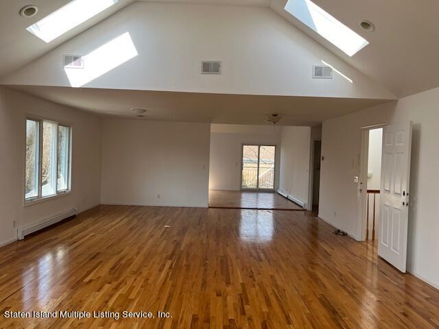 21 Alverson Loop Staten Island, NY 10309 - Photo 13 of 22 a view of empty room with window and wooden floor