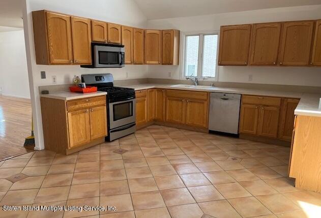 21 Alverson Loop Staten Island, NY 10309 - Photo 14 of 22 a kitchen with stainless steel appliances granite countertop a stove a sink and a microwave