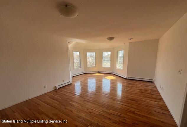 21 Alverson Loop Staten Island, NY 10309 - Photo 18 of 22 a view of lot of kitchen with wooden floor and window