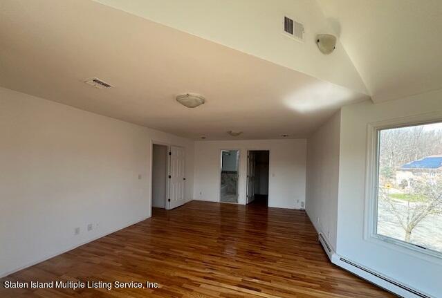 21 Alverson Loop Staten Island, NY 10309 - Photo 19 of 22 a view of an empty room with wooden floor and a window
