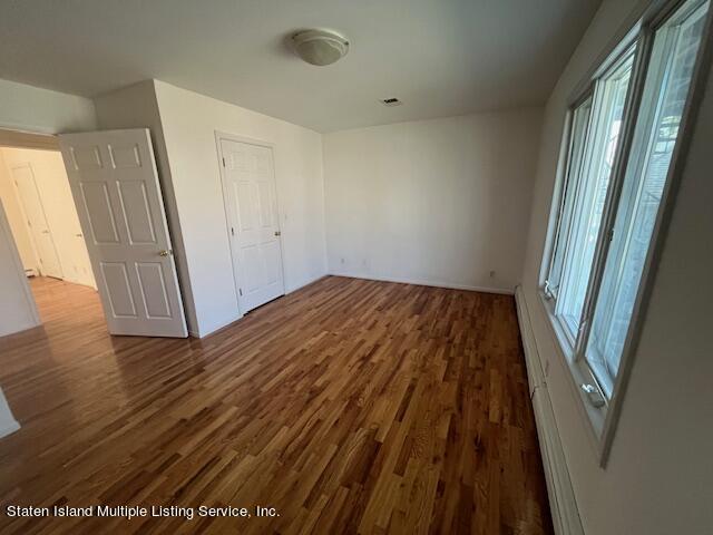21 Alverson Loop Staten Island, NY 10309 - Photo 6 of 22 a view of a room with wooden floor and staircase