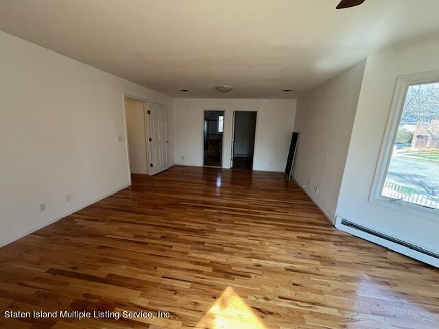 21 Alverson Loop Staten Island, NY 10309 - Photo 9 of 22 a view of a room with window and wooden floor