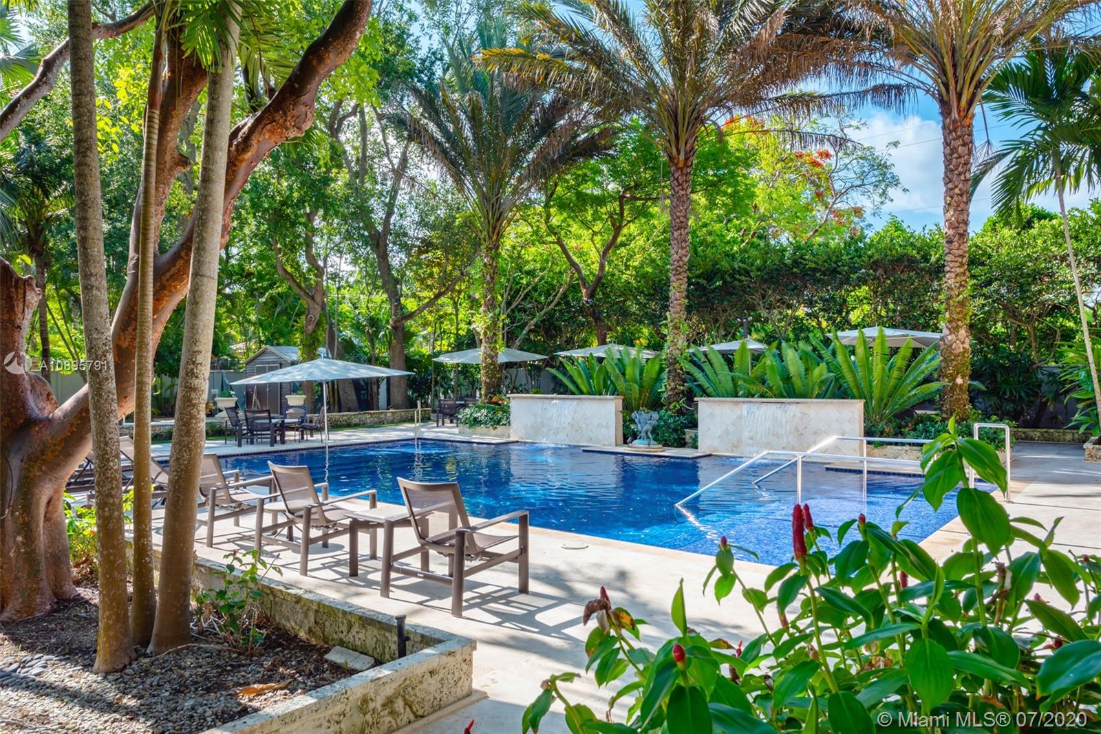 4800 Pine Drive Miami, FL 33143 - Photo 16 of 58 a view of a patio with table and chairs potted plants and large tree