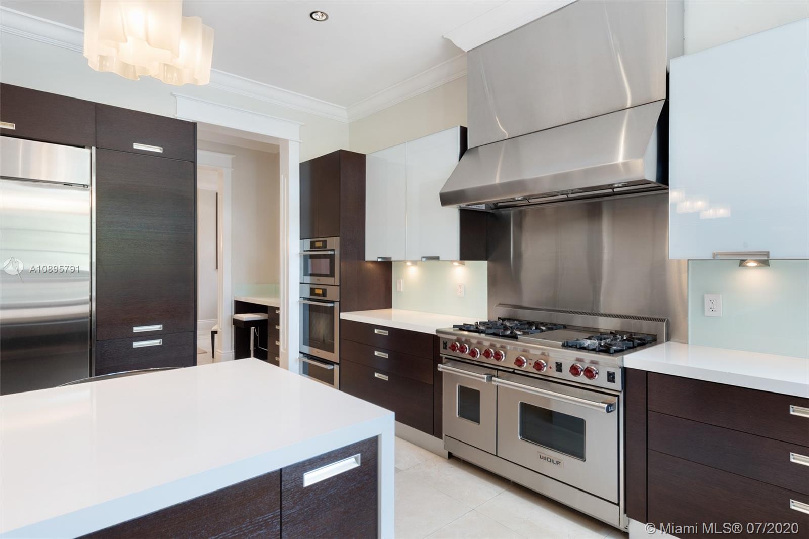 4800 Pine Drive Miami, FL 33143 - Photo 20 of 58 a kitchen with stainless steel appliances a stove and a refrigerator