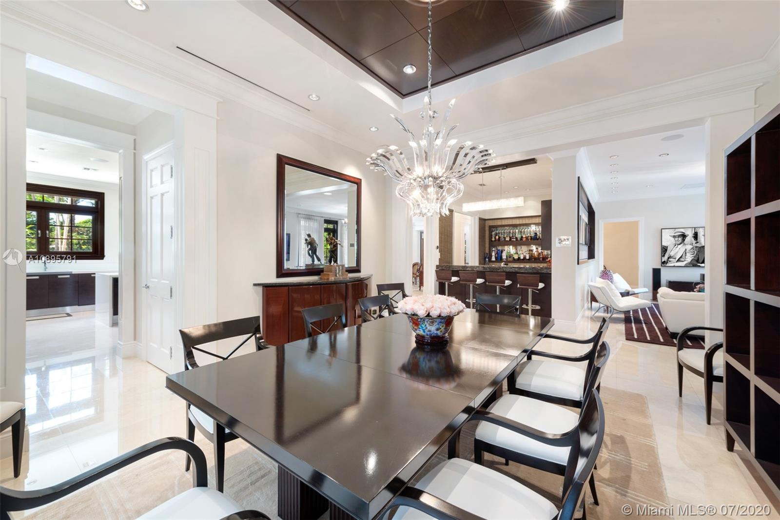 4800 Pine Drive Miami, FL 33143 - Photo 23 of 58 a view of a dining room with furniture and a chandelier