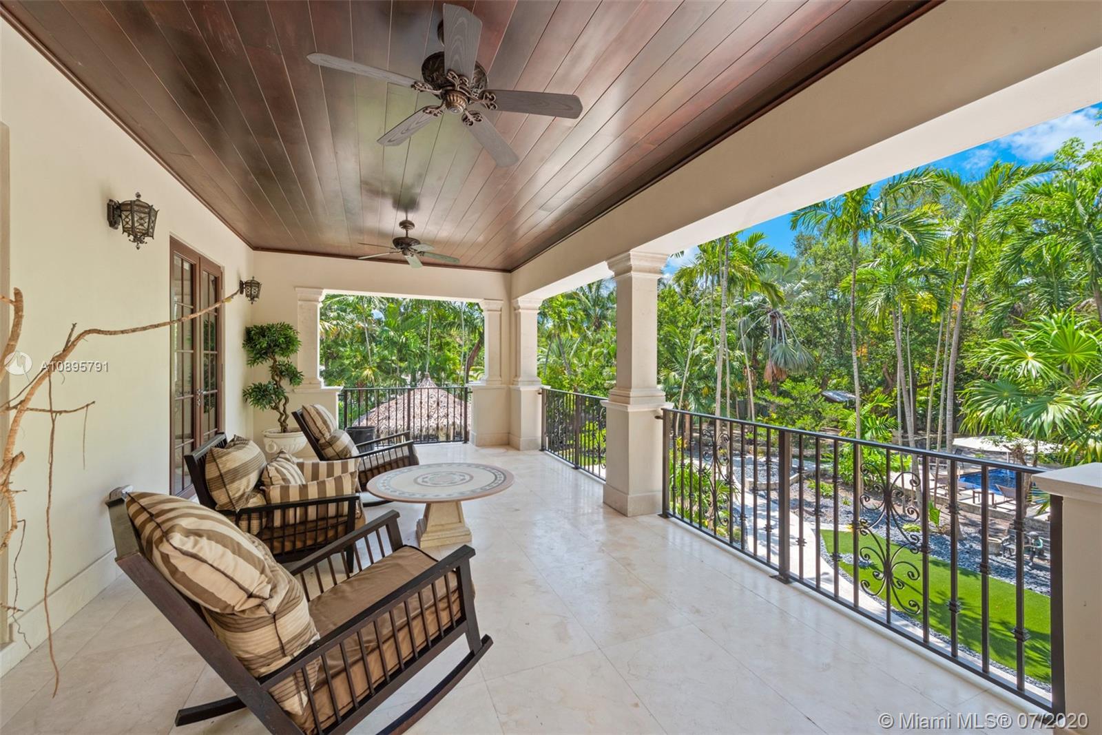 4800 Pine Drive Miami, FL 33143 - Photo 30 of 58 a view of a porch with furniture and a yard