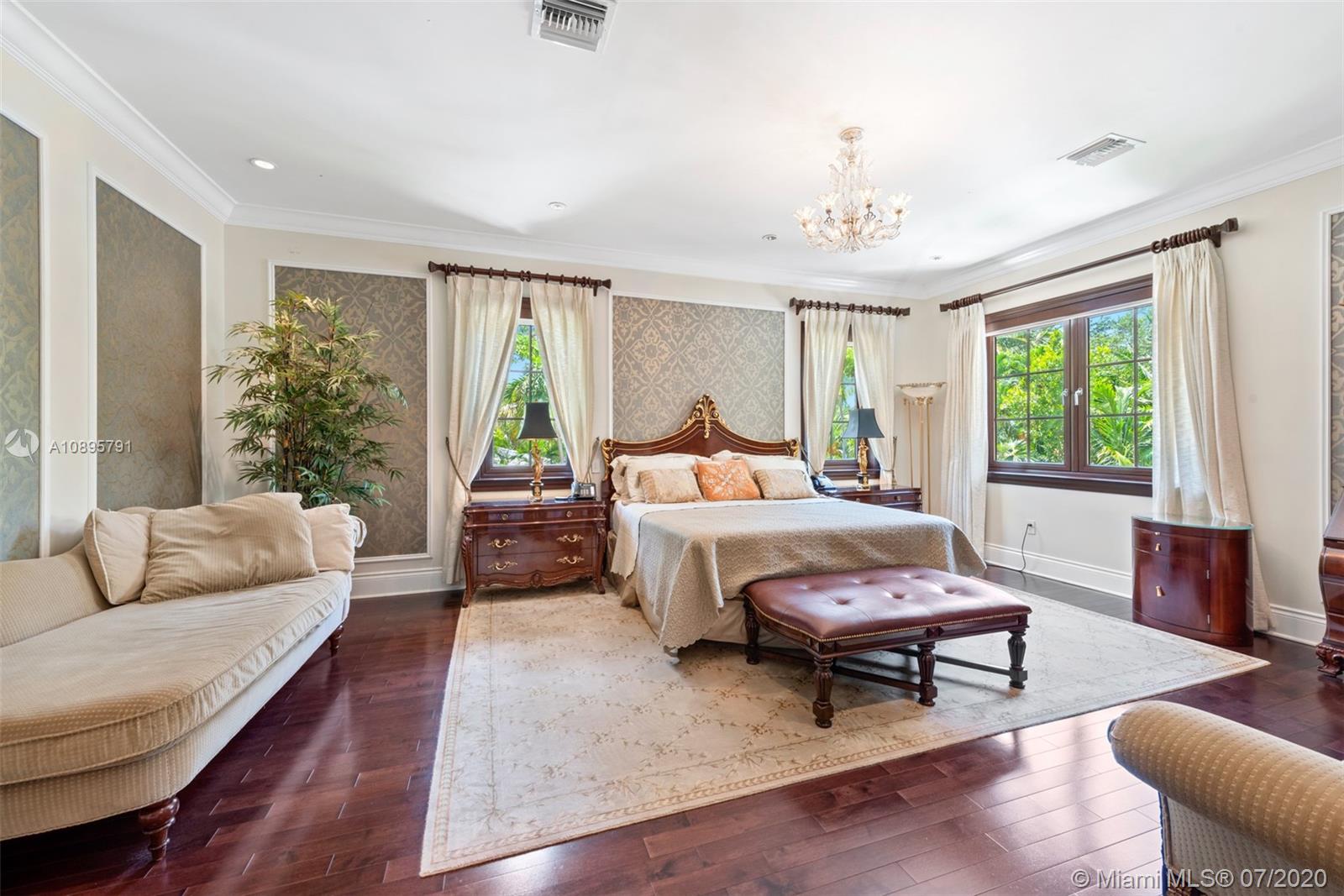 4800 Pine Drive Miami, FL 33143 - Photo 31 of 58 a bedroom with a bed wooden floor and a large window