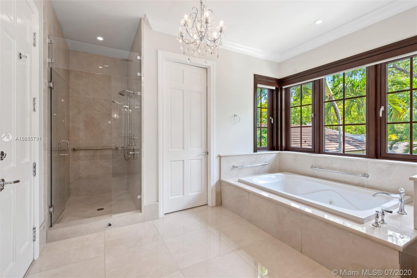 4800 Pine Drive Miami, FL 33143 - Photo 34 of 58 a spacious bathroom with a tub shower and windows