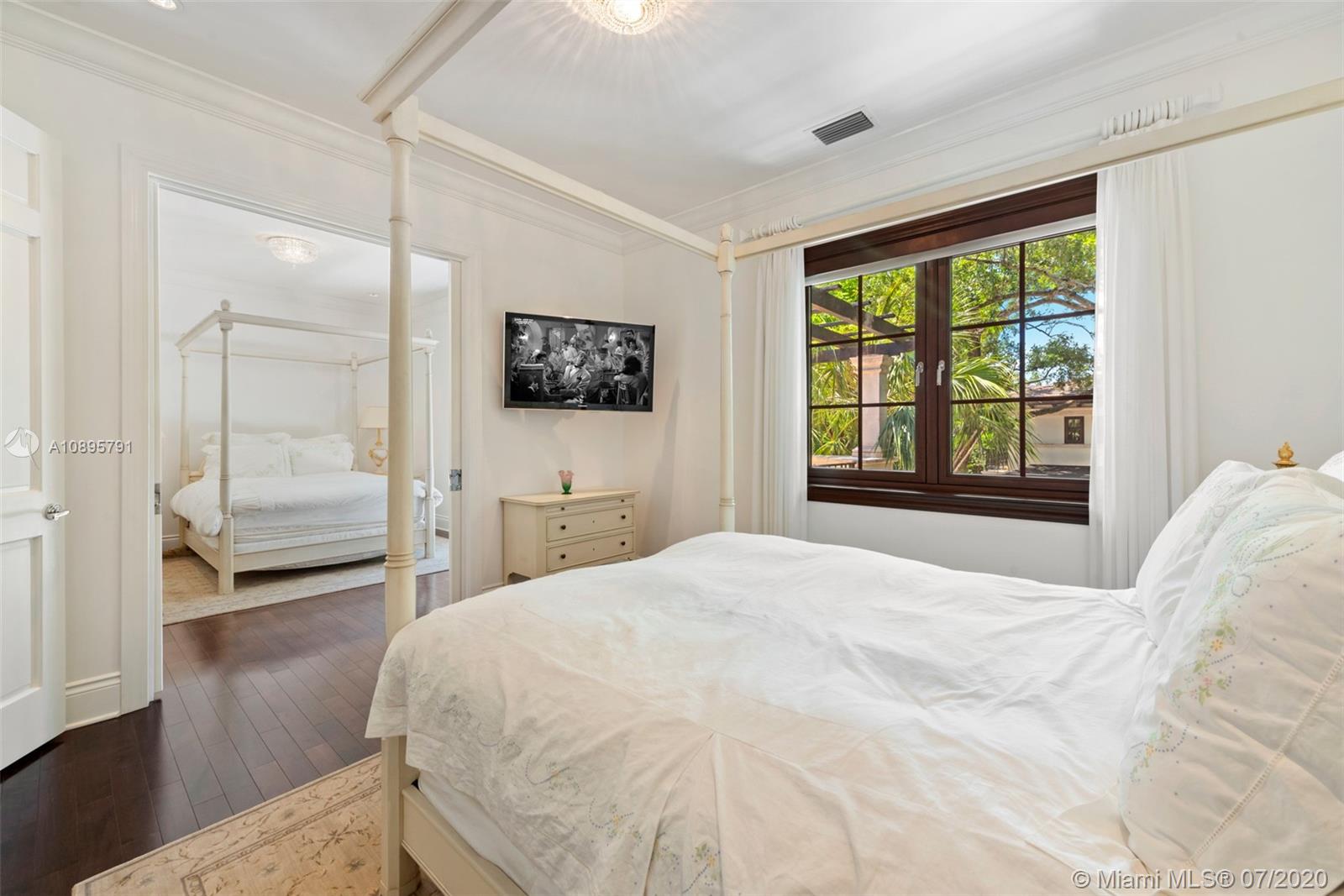 4800 Pine Drive Miami, FL 33143 - Photo 35 of 58 a bedroom with a bed and a flat screen tv