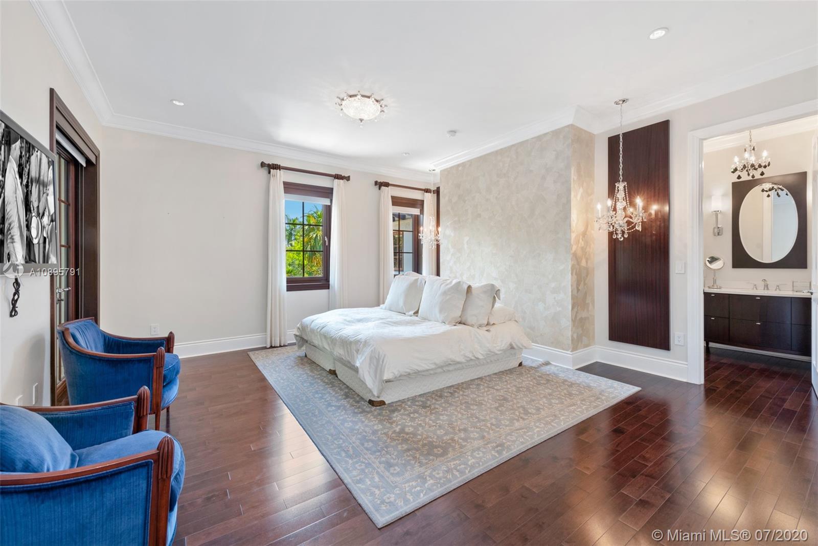 4800 Pine Drive Miami, FL 33143 - Photo 38 of 58 a spacious bedroom with a bed and wooden floor