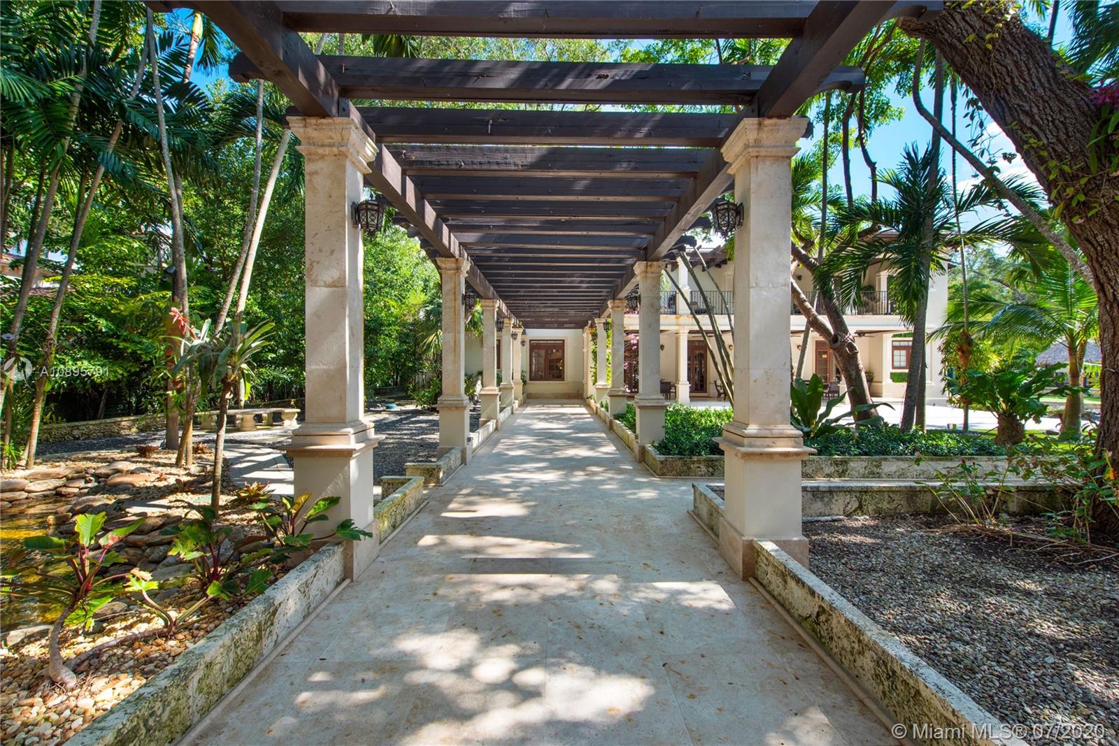 4800 Pine Drive Miami, FL 33143 - Photo 41 of 58 a view of a patio with table and chairs with wooden floor and fence