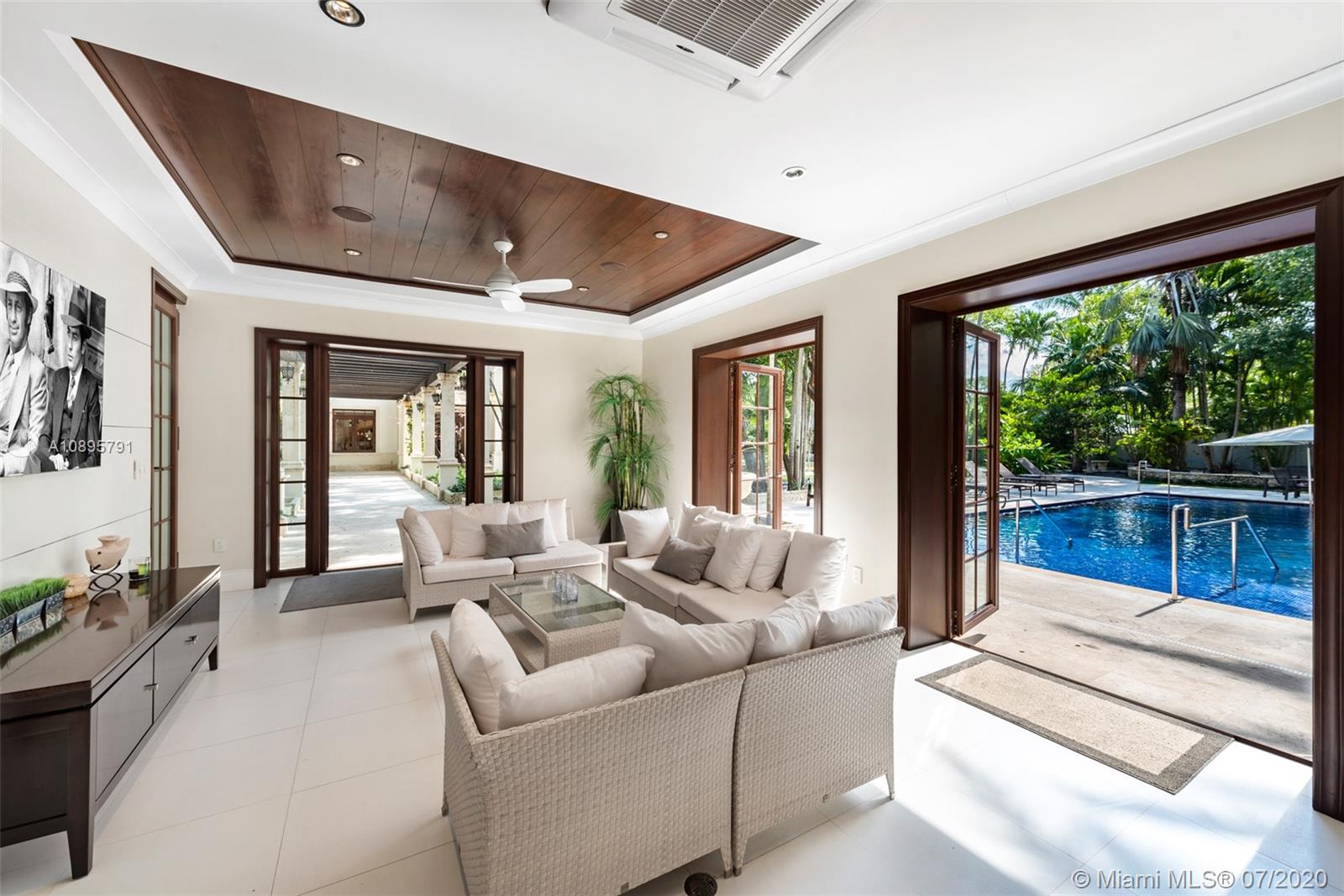 4800 Pine Drive Miami, FL 33143 - Photo 43 of 58 a living room with furniture and large windows