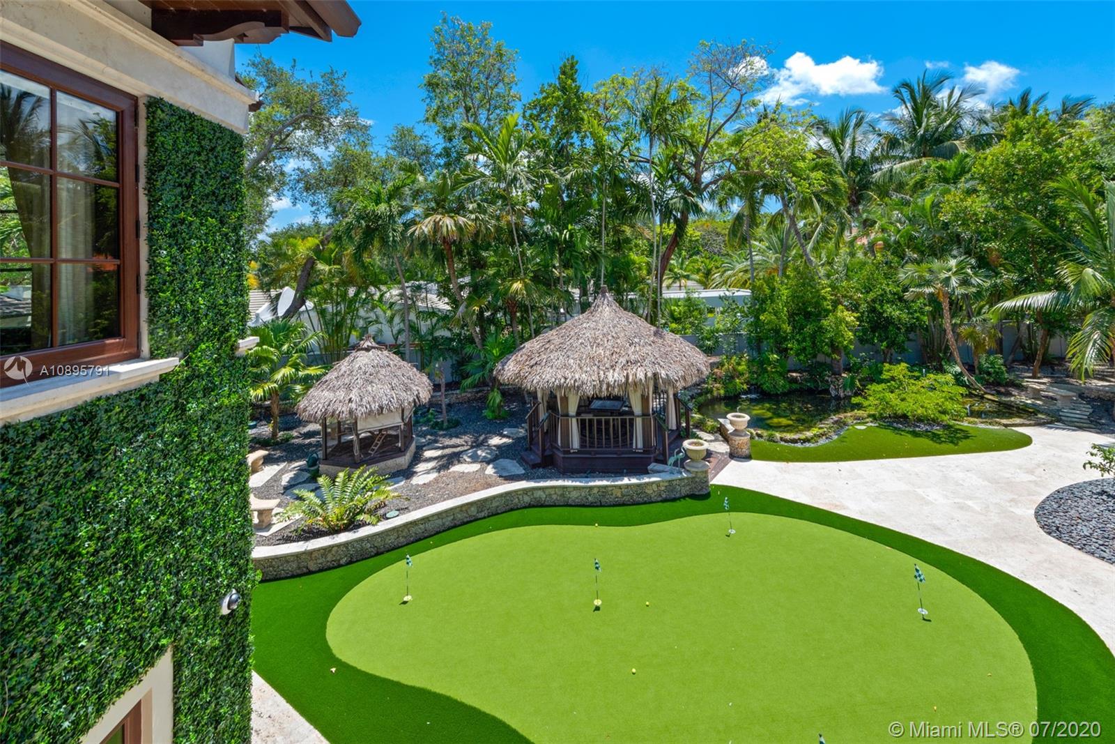 4800 Pine Drive Miami, FL 33143 - Photo 47 of 58 a view of a swimming pool and lounge chairs