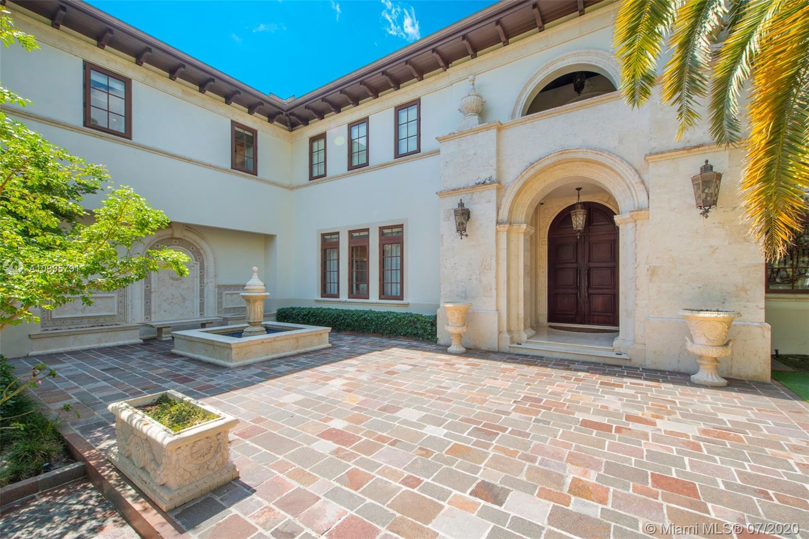 4800 Pine Drive Miami, FL 33143 - Photo 5 of 58 a view of a brick house with many windows