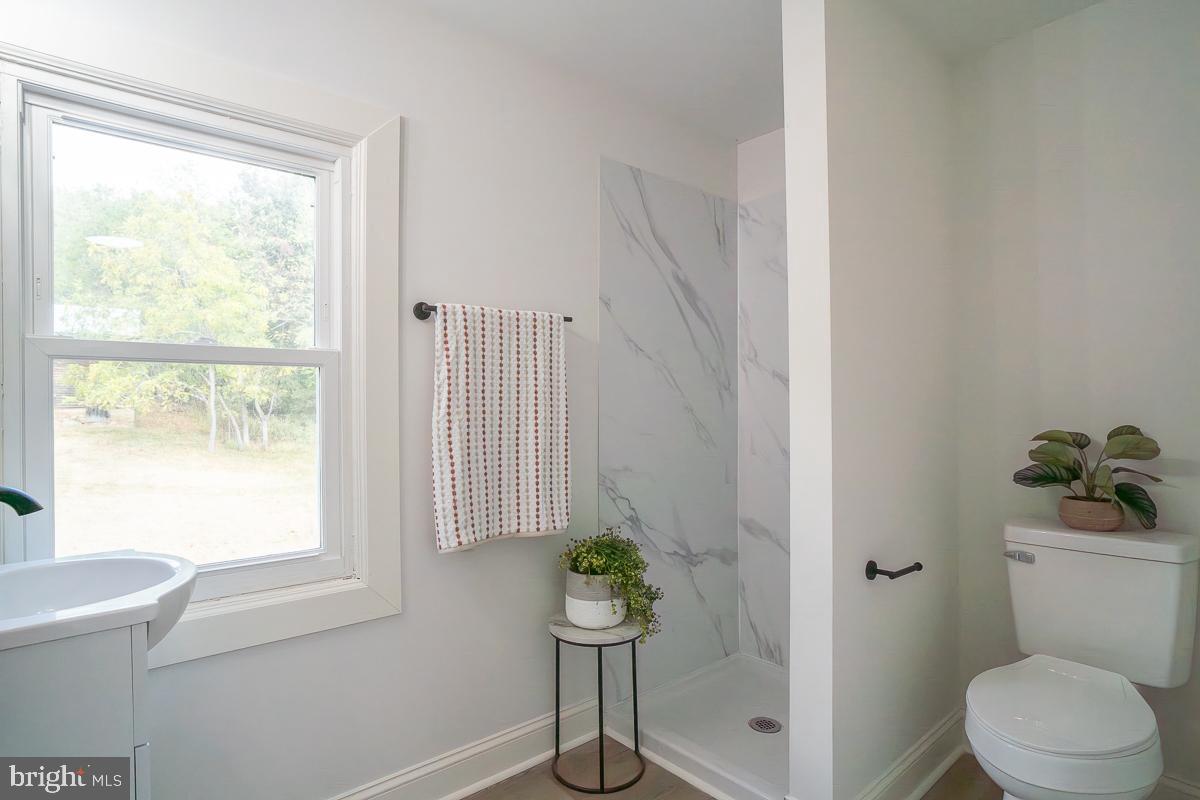 4771 Mill Creek Road Mount Jackson, VA 22842 - Photo 12 of 29 a bathroom with a toilet and a window