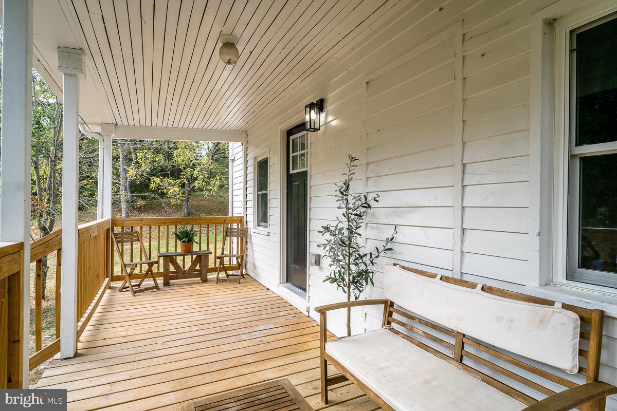 4771 Mill Creek Road Mount Jackson, VA 22842 - Photo 16 of 29 a view of a balcony with chairs and wooden floor