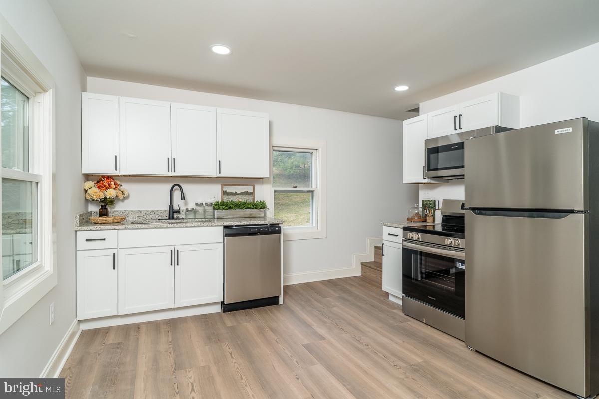 4771 Mill Creek Road Mount Jackson, VA 22842 - Photo 2 of 29 a kitchen with granite countertop white cabinets and stainless steel appliances