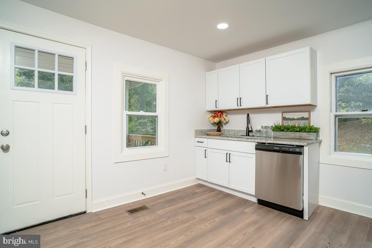 4771 Mill Creek Road Mount Jackson, VA 22842 - Photo 3 of 29 a kitchen with granite countertop white cabinets and white appliances