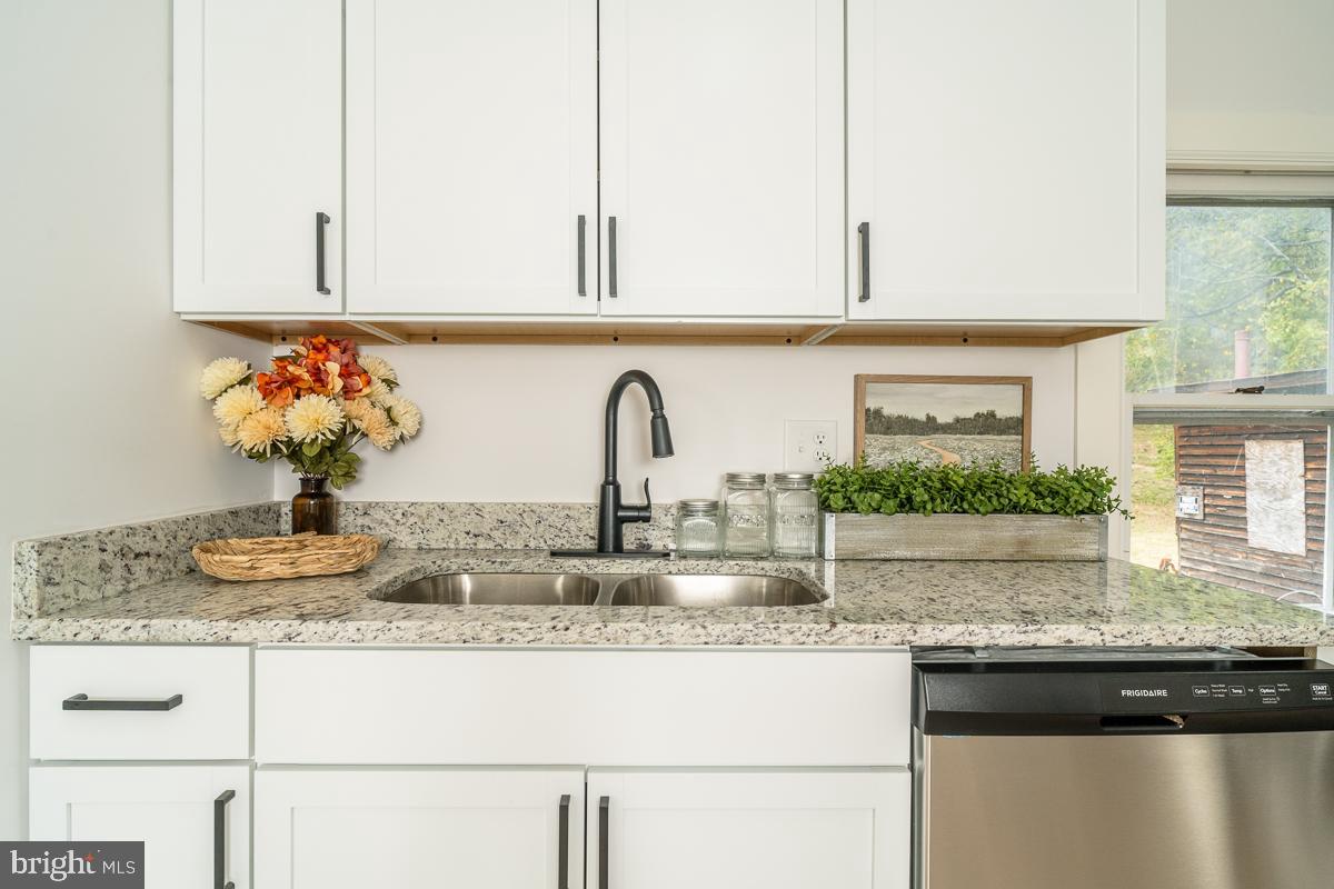 4771 Mill Creek Road Mount Jackson, VA 22842 - Photo 4 of 29 a kitchen with granite countertop a sink a stove and cabinets