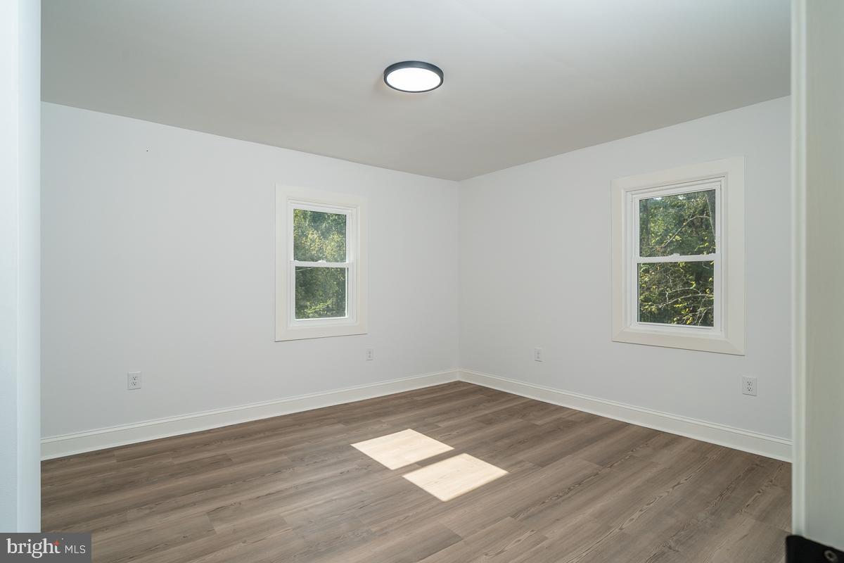 4771 Mill Creek Road Mount Jackson, VA 22842 - Photo 9 of 29 an empty room with wooden floor and windows