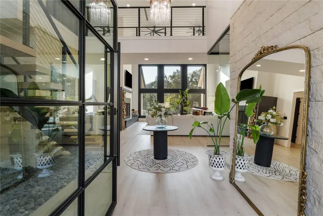 a dining room with furniture and a floor to ceiling window
