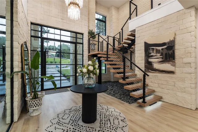 a view of entryway and hall with wooden floor