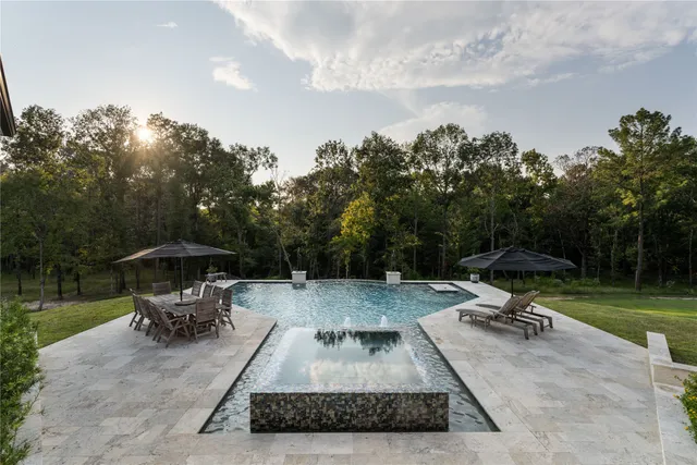 a view of a backyard with sitting area