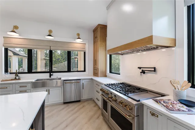 a large kitchen with cabinets table and chairs